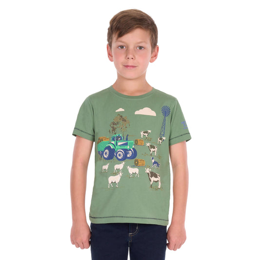 A young boy wearing a sage green short-sleeve t-shirt with a colorful farm graphic print, paired with dark blue jeans, photographed against a solid white background.
