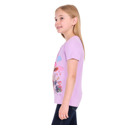 A young girl with blonde hair is shown in profile wearing a light purple short-sleeve t-shirt with a colorful graphic print on the front, paired with dark blue jeans, against a plain white background.