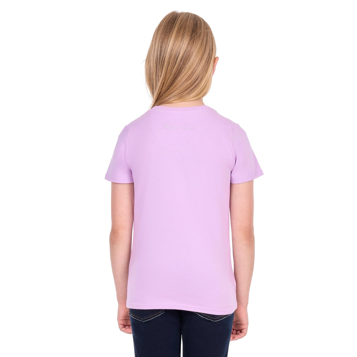 A young girl with blonde hair, viewed from behind, wearing a light purple short-sleeve t-shirt and dark blue jeans against a white background.