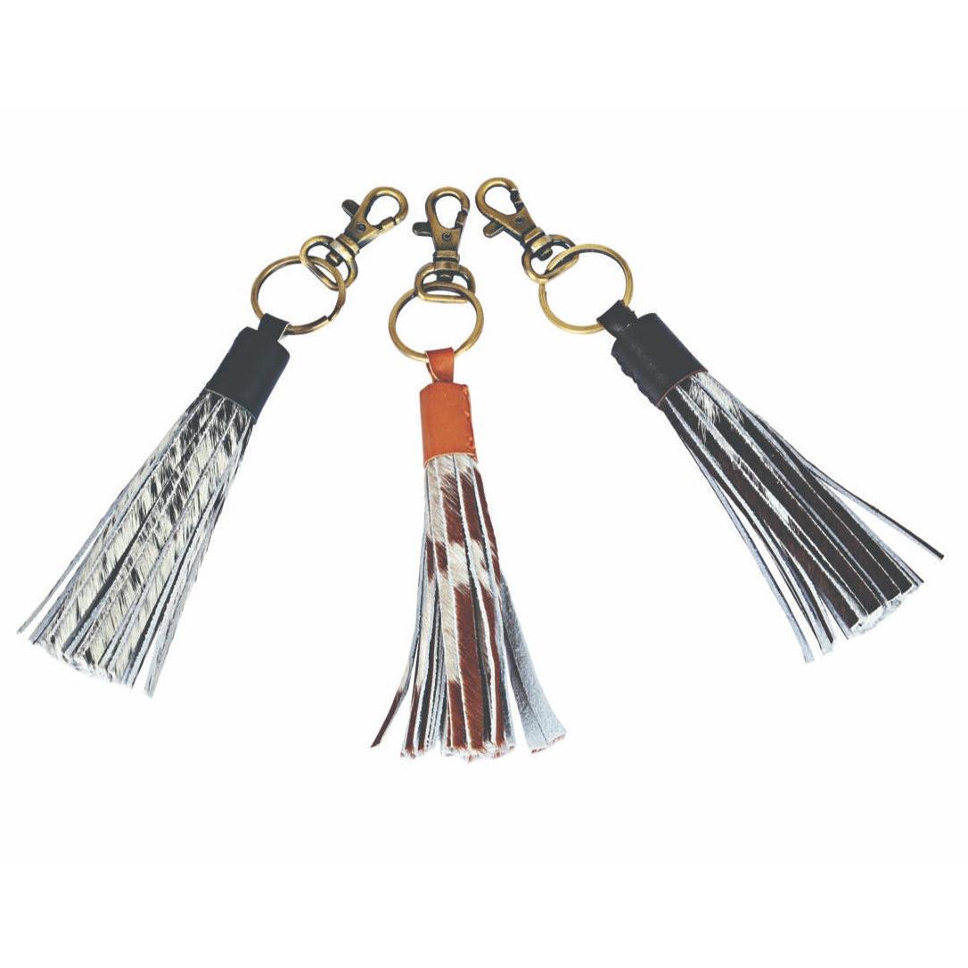 Three tassel keychains with different color schemes on a white background